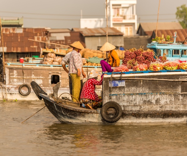 Boat arriving in floating market, Mekong Delta